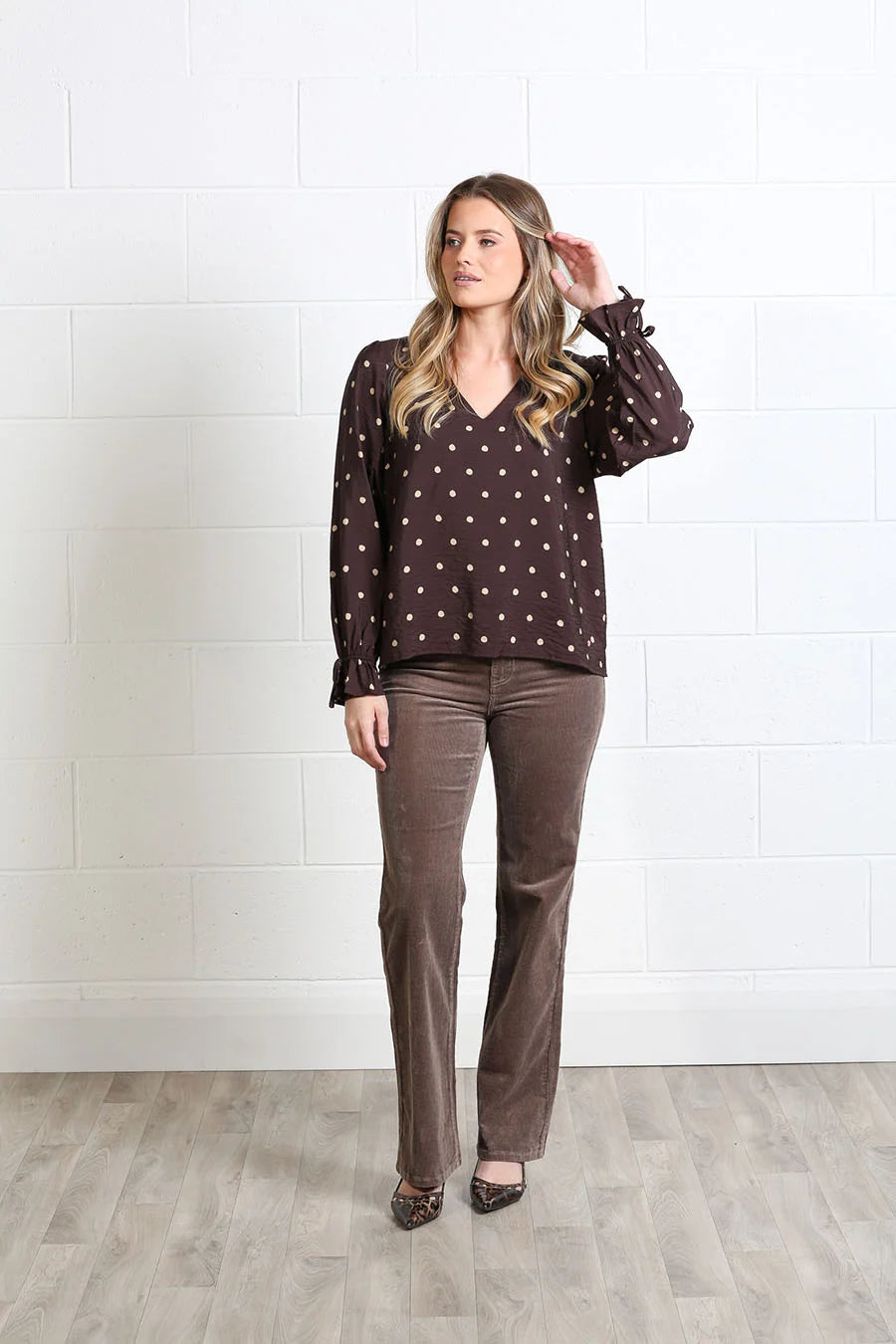 Rant & Rave Sophia Top in chocolate dot print, front view worn by model with V-neck and long sleeves.