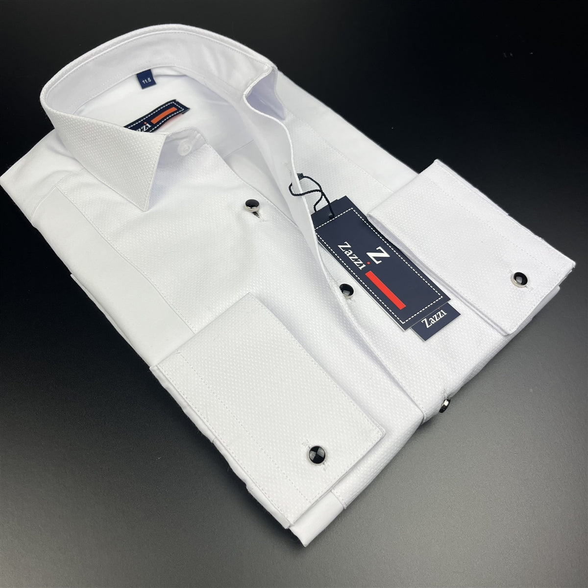 Folded boys white dress shirt with black buttons and brand tag