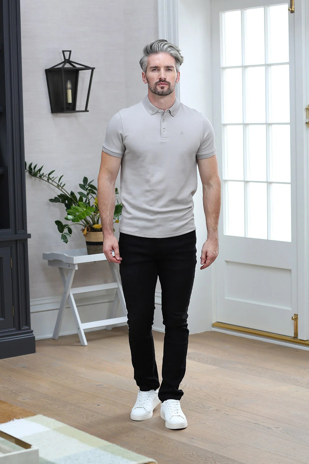 Kenrow Brett Polo in putty worn by a model with black trousers and white sneakers, full - length front view.