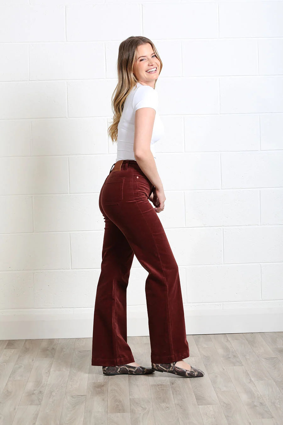 Rant & Rave Bridget cord wide leg trousers in terracotta, angled back model view.