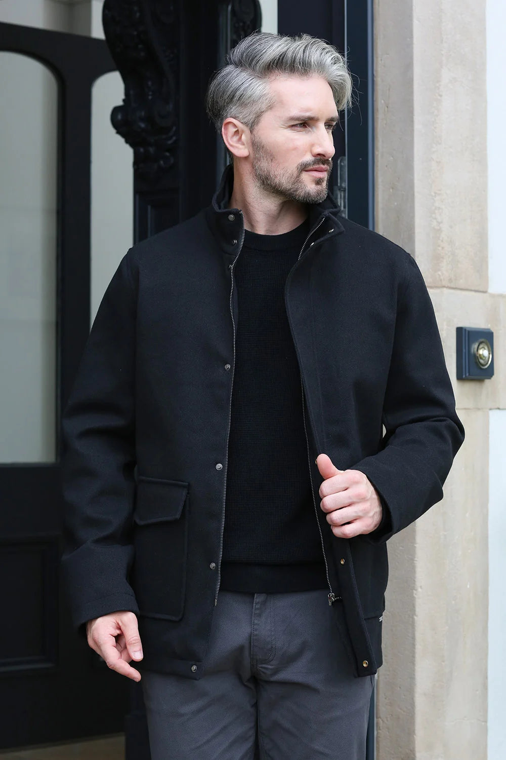 Kenrow Huxley Coat in black, angled model view showing zip and popper fastenings