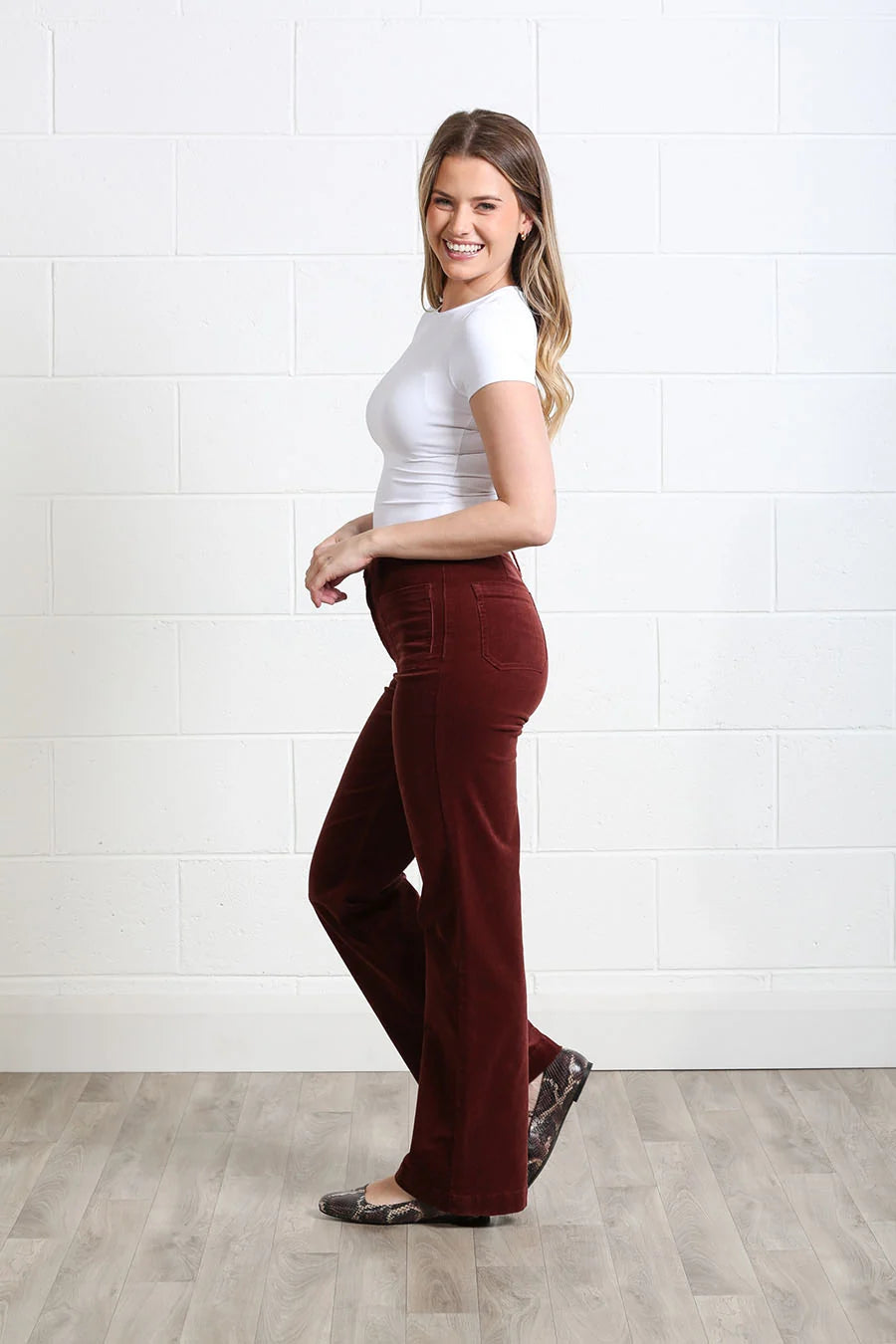 Rant & Rave Bridget cord wide leg trousers in terracotta, side model view.