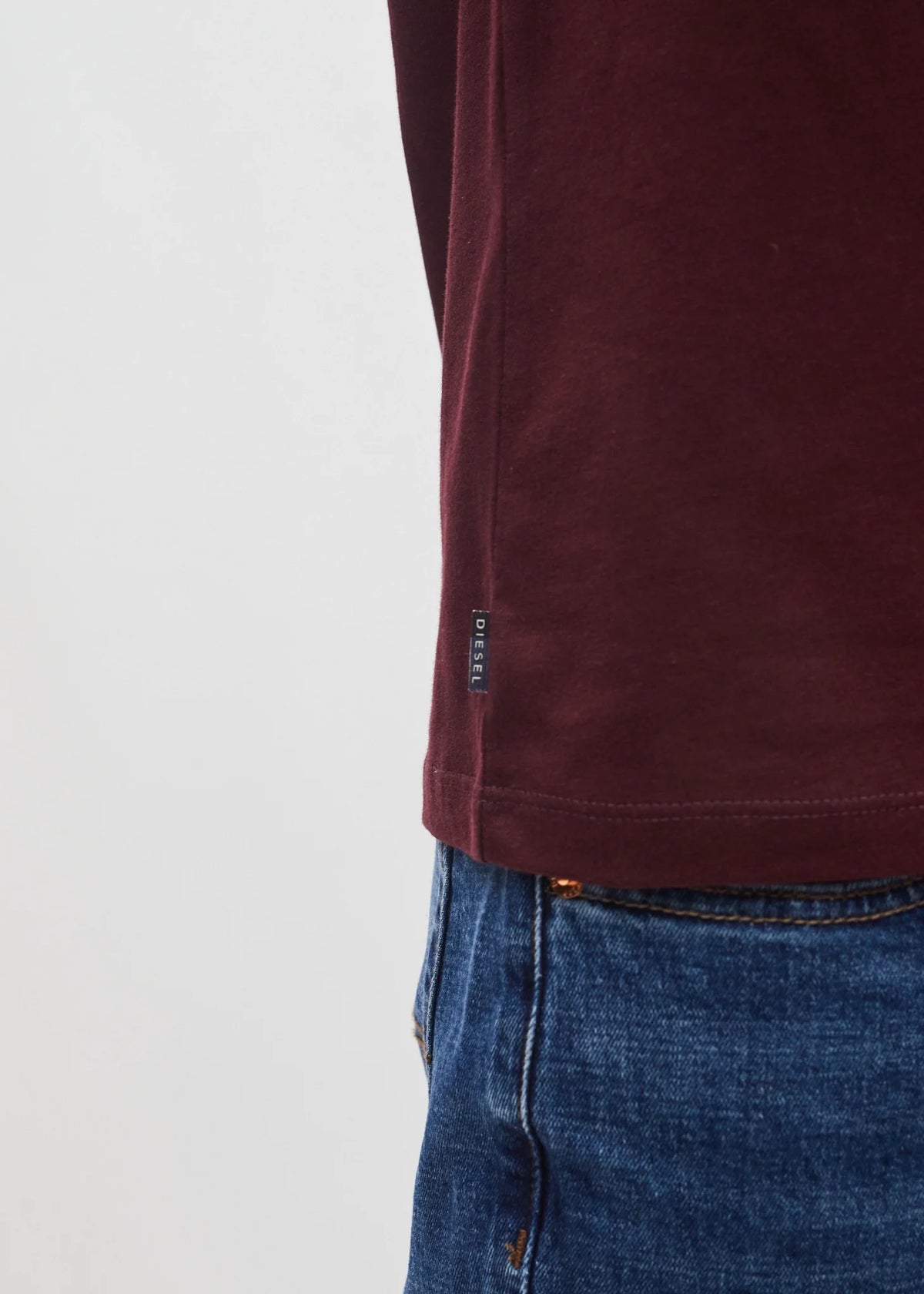 Diesel John Tee in deep burgundy, detail view of side hem tag