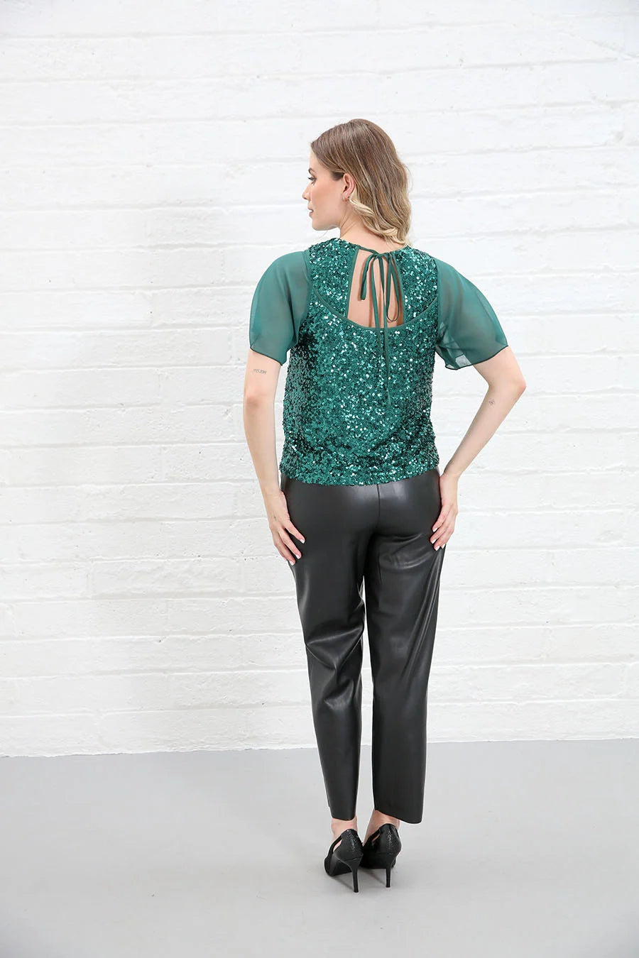 Rant & Rave Kennedy Top in green sequin back view showing tie detail worn by model