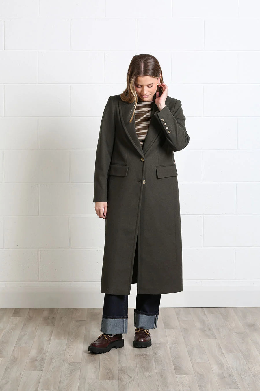 Rant & Rave Olivia Coat in deep moss, angled model view with flap pockets and button front