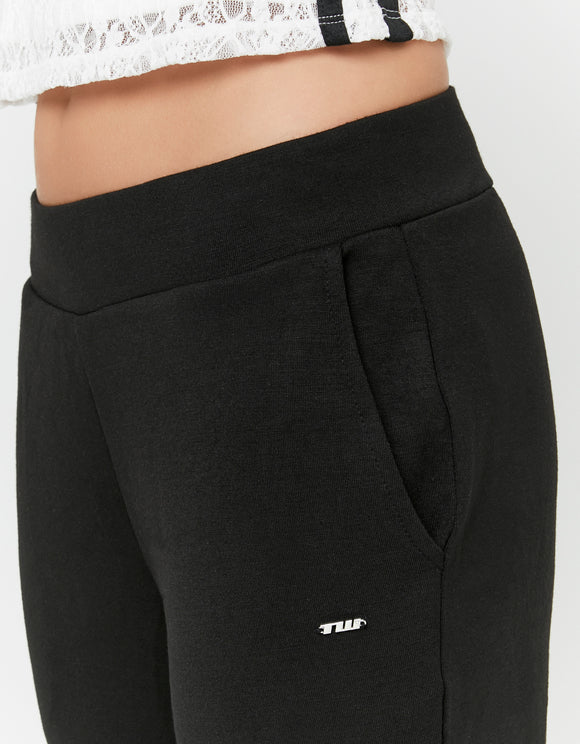 Detail view of the Tally Weijl black flared trousers waistband and side pocket with small logo