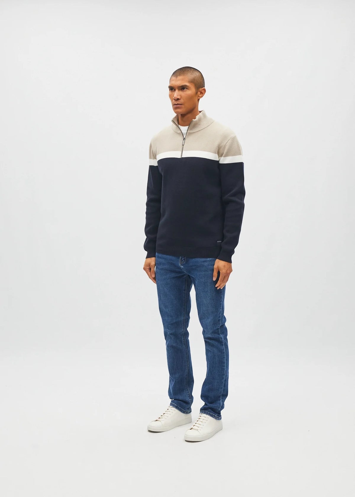 Diesel Tully Half Zip Sandshore sweater in sand, angled model view with white stripe and navy lower section.