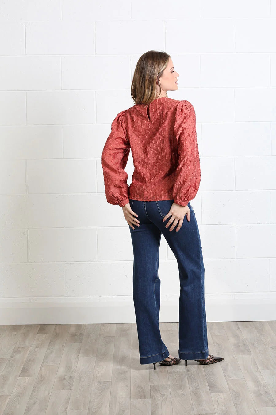 Rant & Rave Zeta Top in terracotta, angled back model view showing the textured finish and back neckline detail.