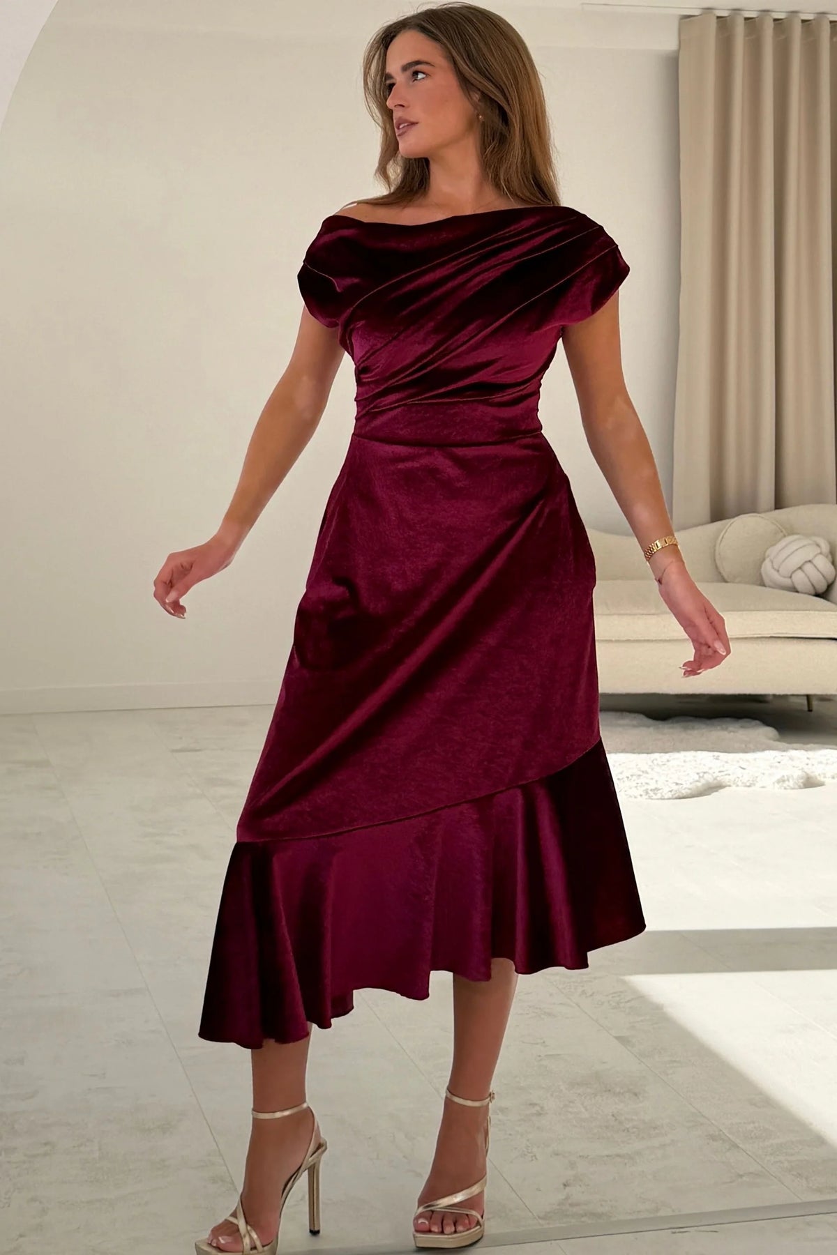 Girl In Mind Felicity asymmetric frill midi dress in berry velvet, back view worn by model with hands in pockets
