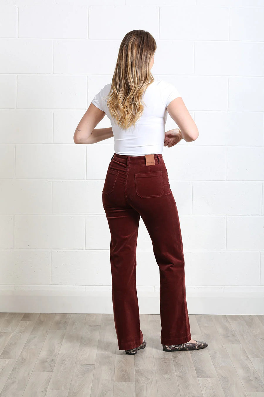 Rant & Rave Bridget cord wide leg trousers in terracotta, back model view.