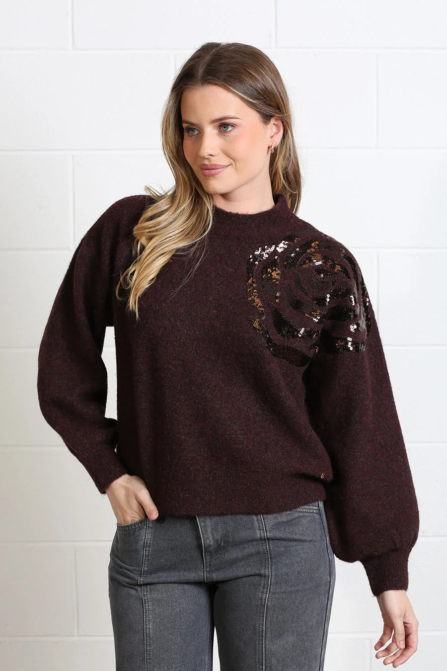 Rant & Rave Sarah Jumper in burgundy worn by model, angled view with hand in pocket