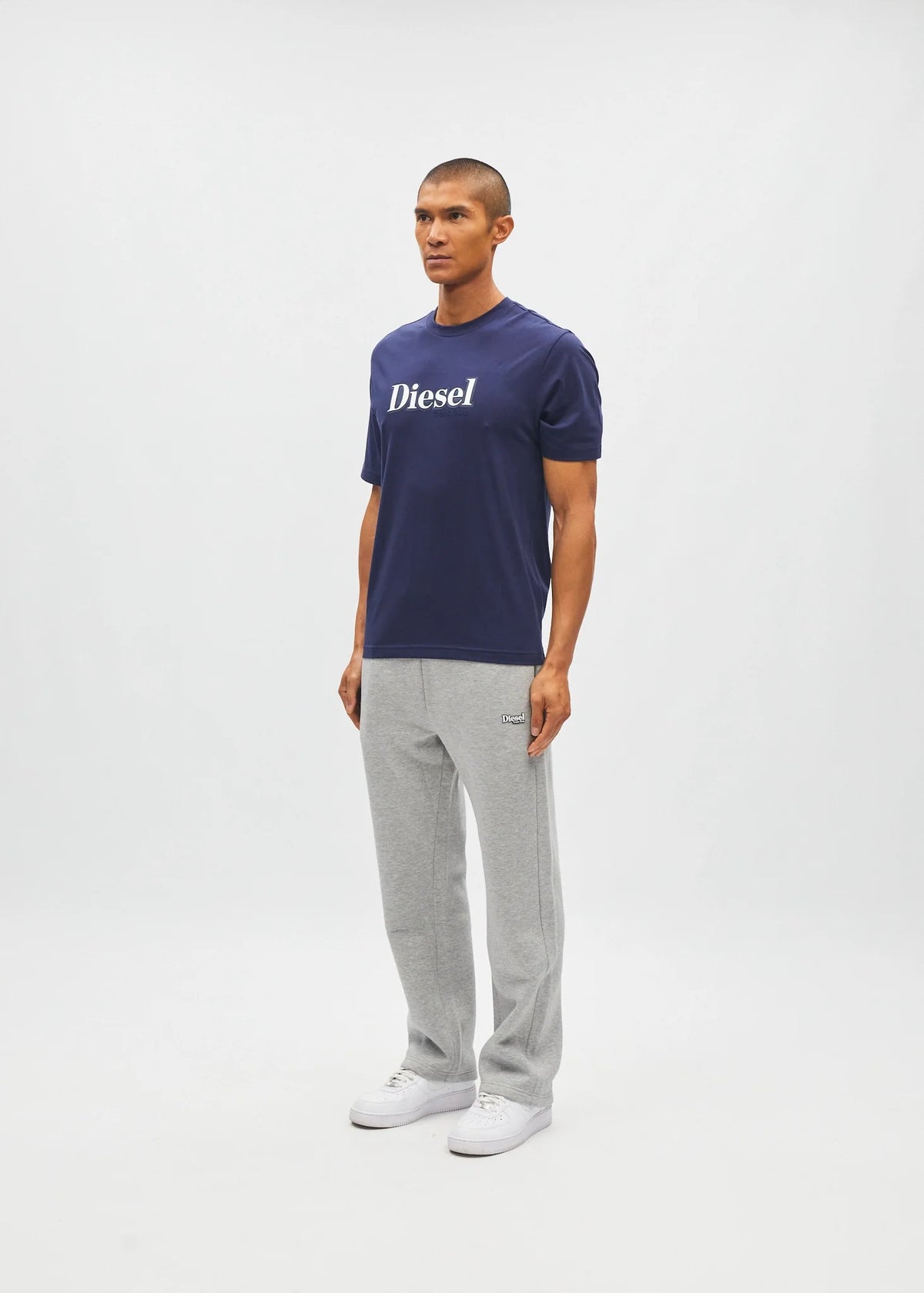 Diesel Walter Tee in navy worn by a model, angled front view with the white Diesel chest logo visible.