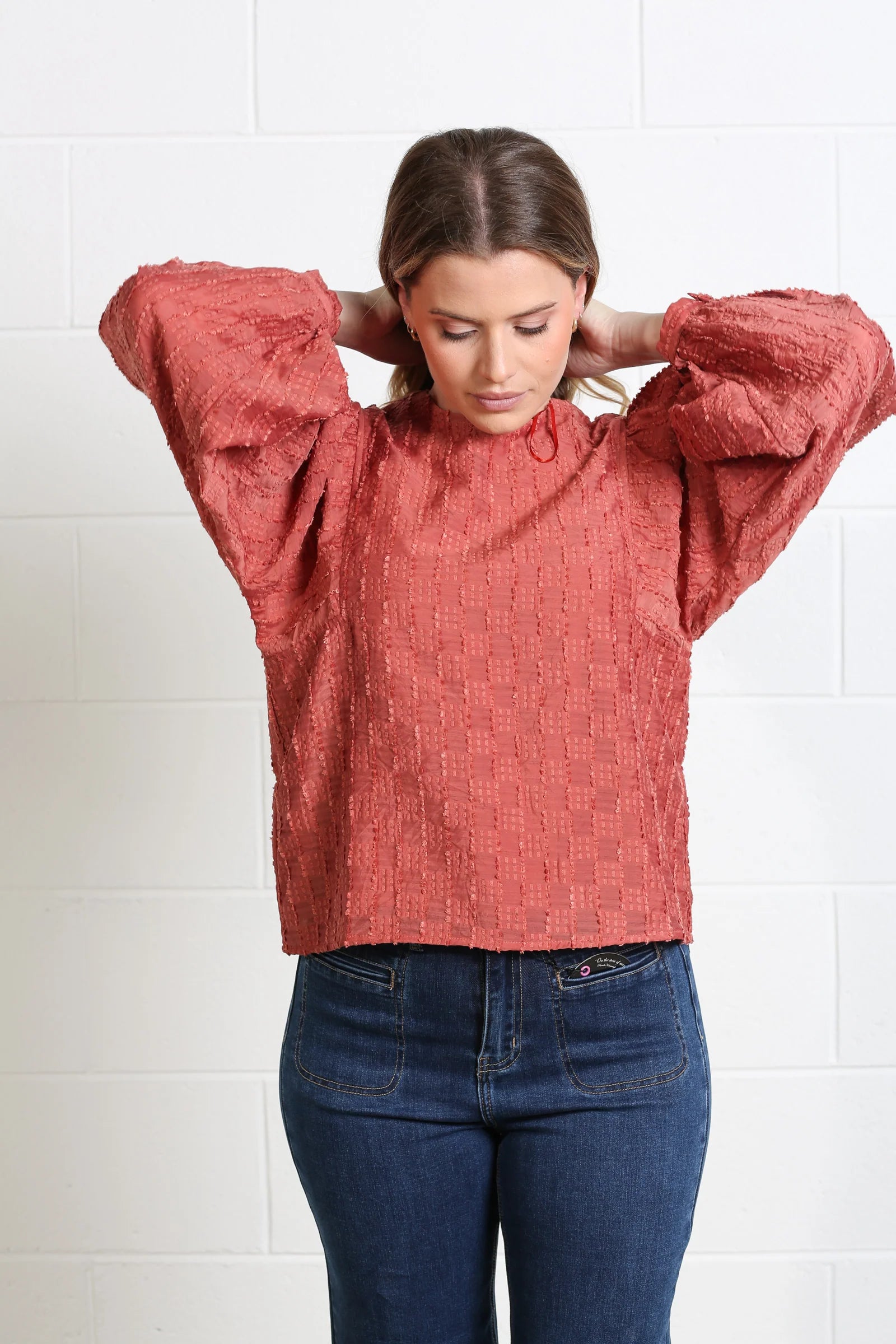 Rant & Rave Zeta Top in terracotta, close front model view highlighting the textured fabric and balloon sleeves.