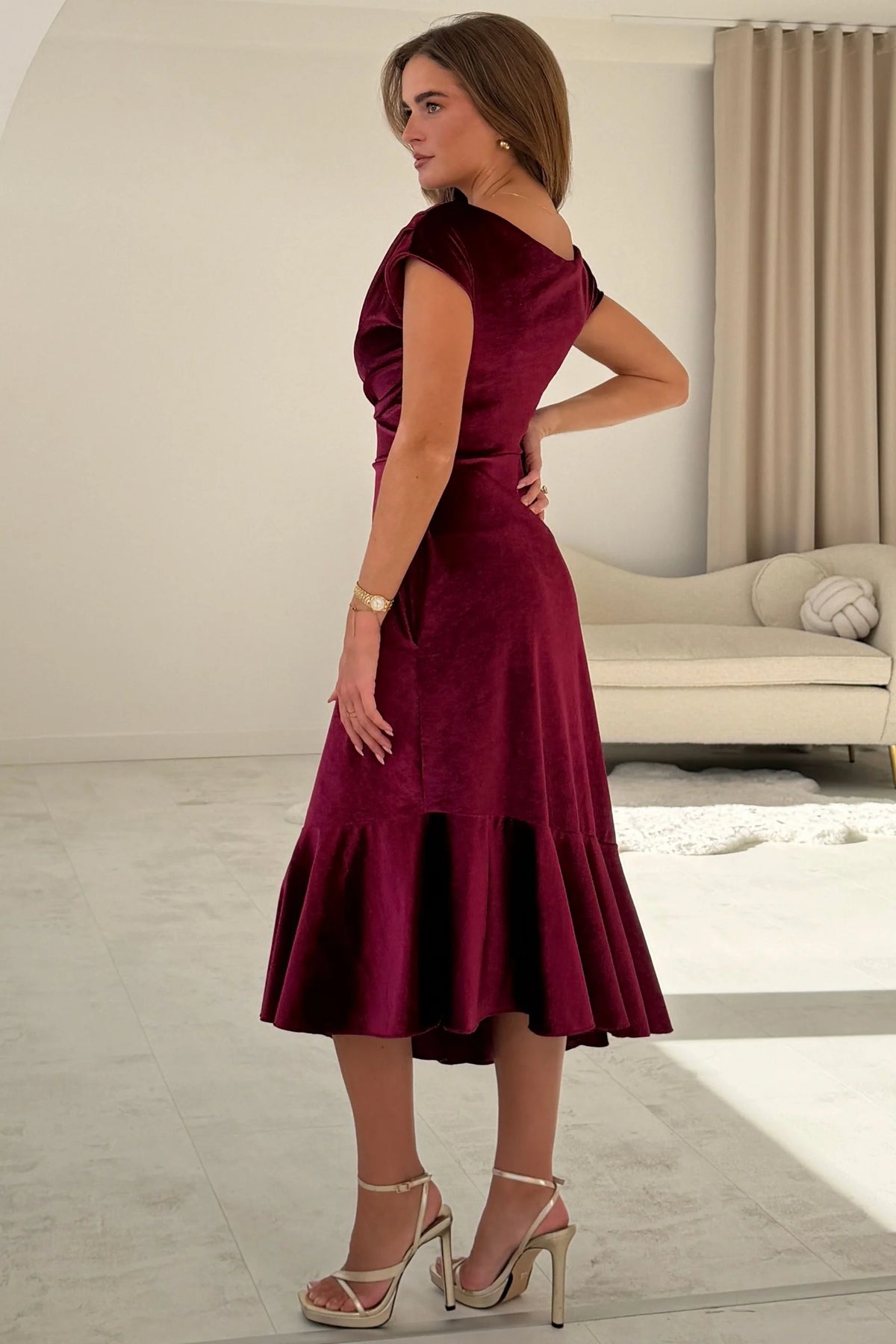 Girl In Mind Felicity asymmetric frill midi dress in berry velvet, rear angled model view highlighting velvet texture
