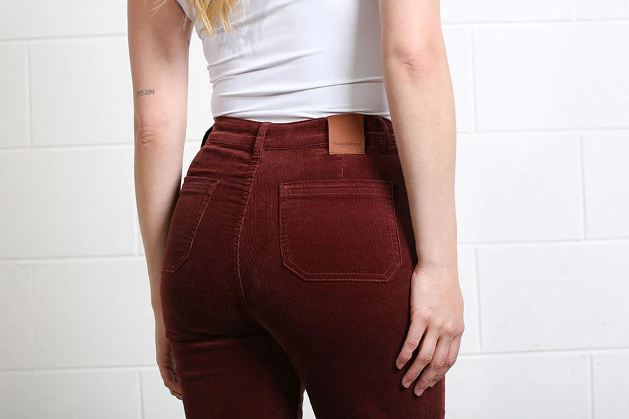 Back detail of Rant & Rave Bridget terracotta cord wide leg trousers with rear pockets.
