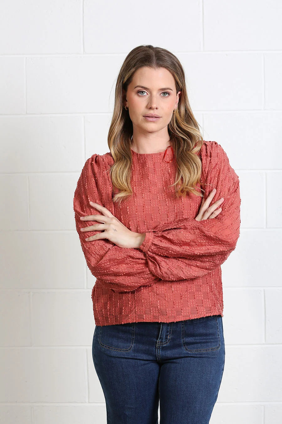 Rant & Rave Zeta Top in terracotta, front model view with textured fabric and gathered long sleeves.