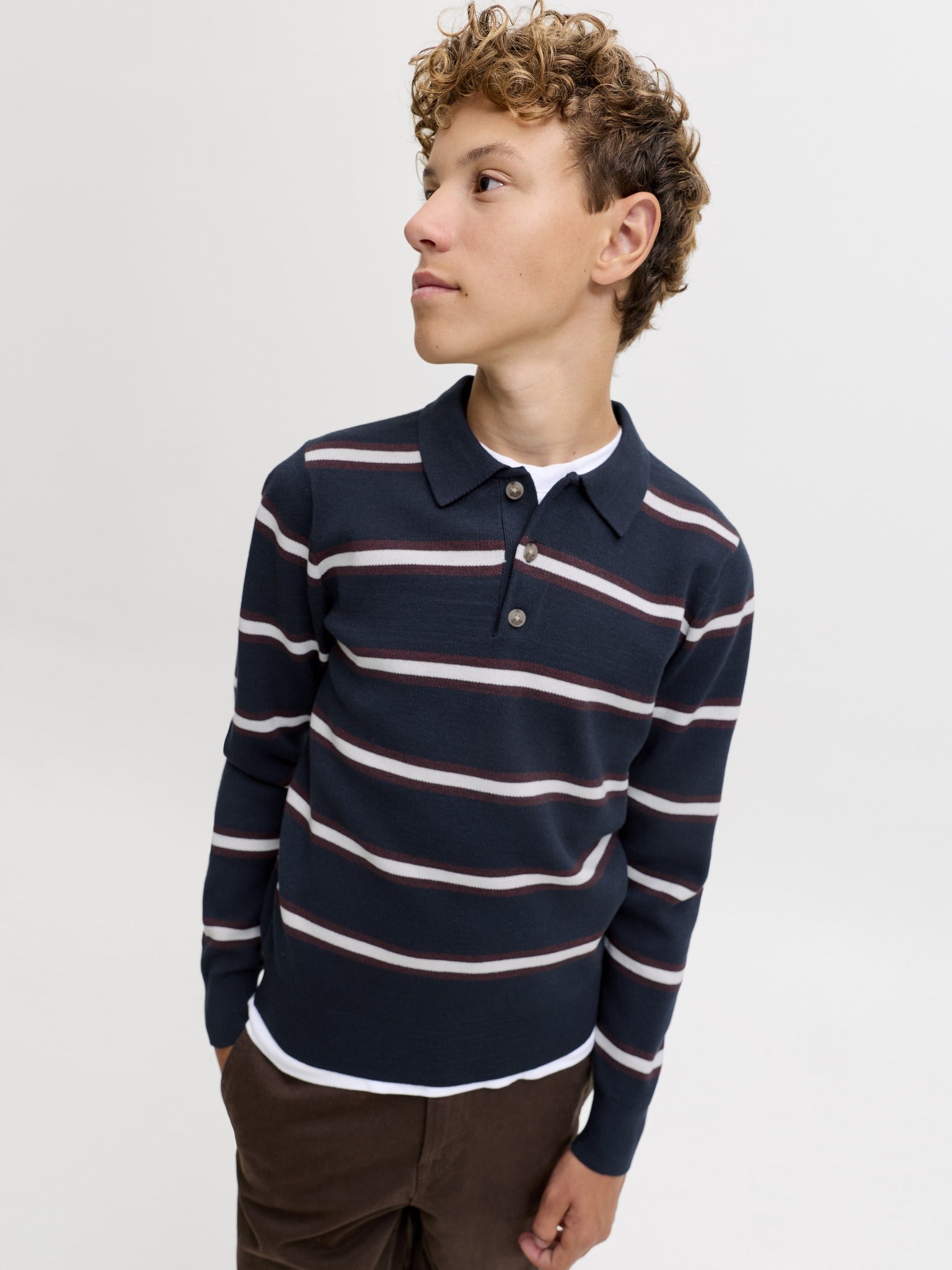 Jack Jones Junior Atocha Knit Stripe Polo Junior in Sky Captain Sea Salt / Chocolate Truffle angled view on model