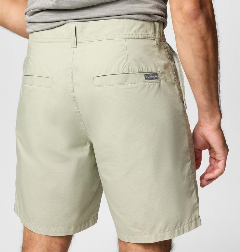 Light green shorts with a brand logo on the back pocket against a white background