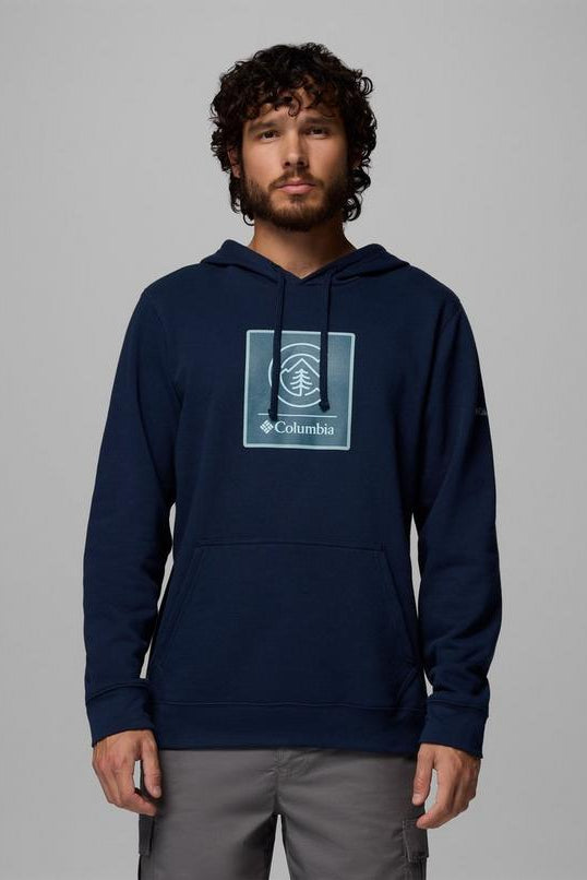 Man wearing a navy blue hoodie with Columbia logo on a gray background