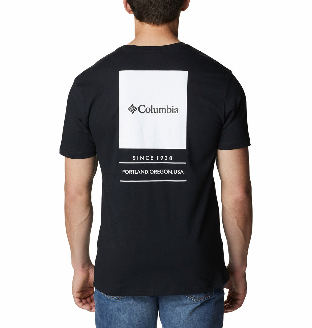 Black t-shirt with Columbia logo and text on the back, worn by a person.