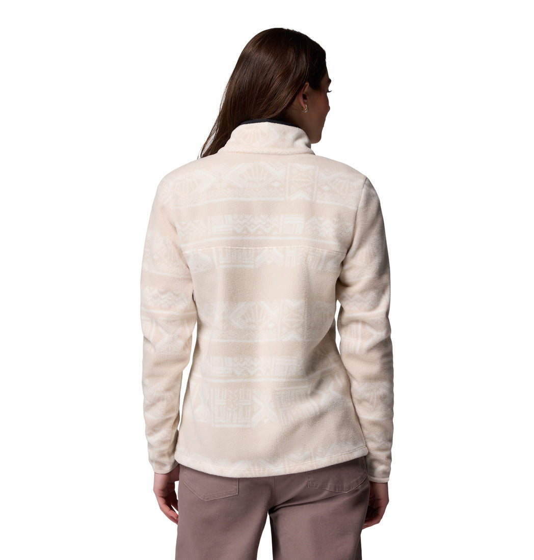 Woman wearing a cream-colored fleece jacket on a white background
