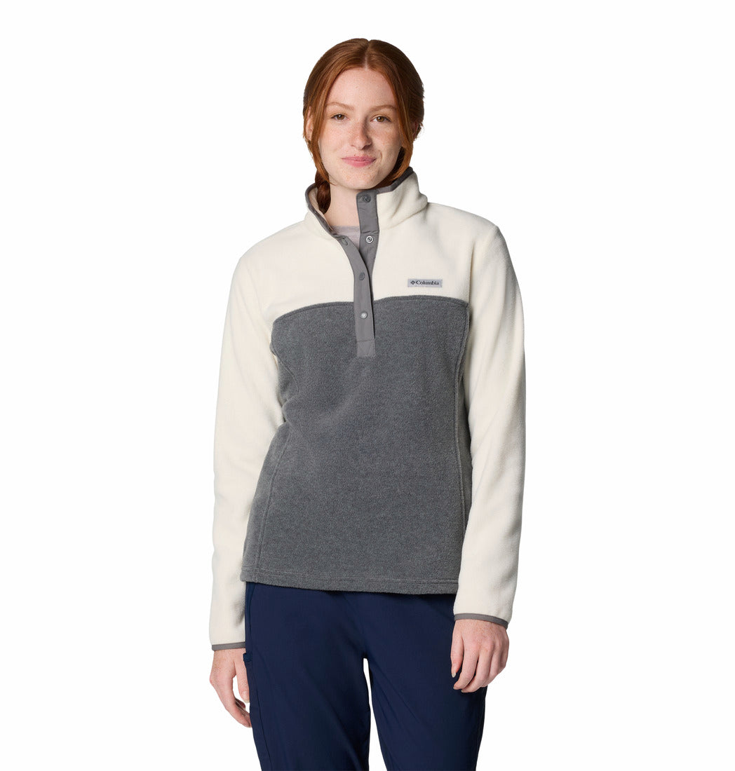 Woman wearing a two-tone fleece pullover with a visible brand logo on a white background