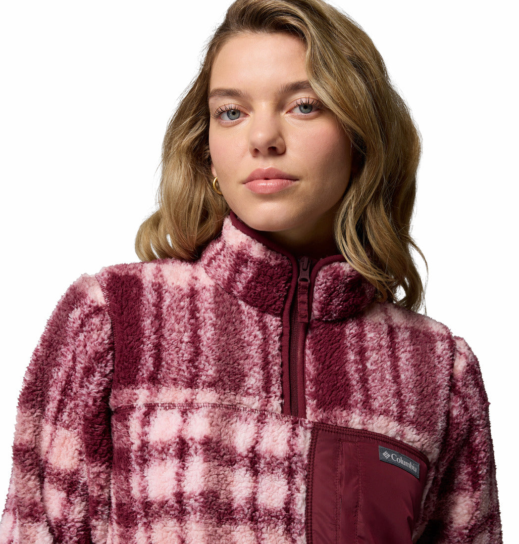 Woman wearing a pink and white plaid fleece jacket with Columbia logo.