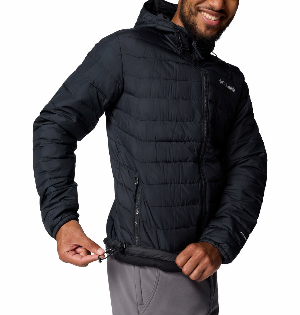 Person wearing a black puffer jacket with Columbia logo on a white background