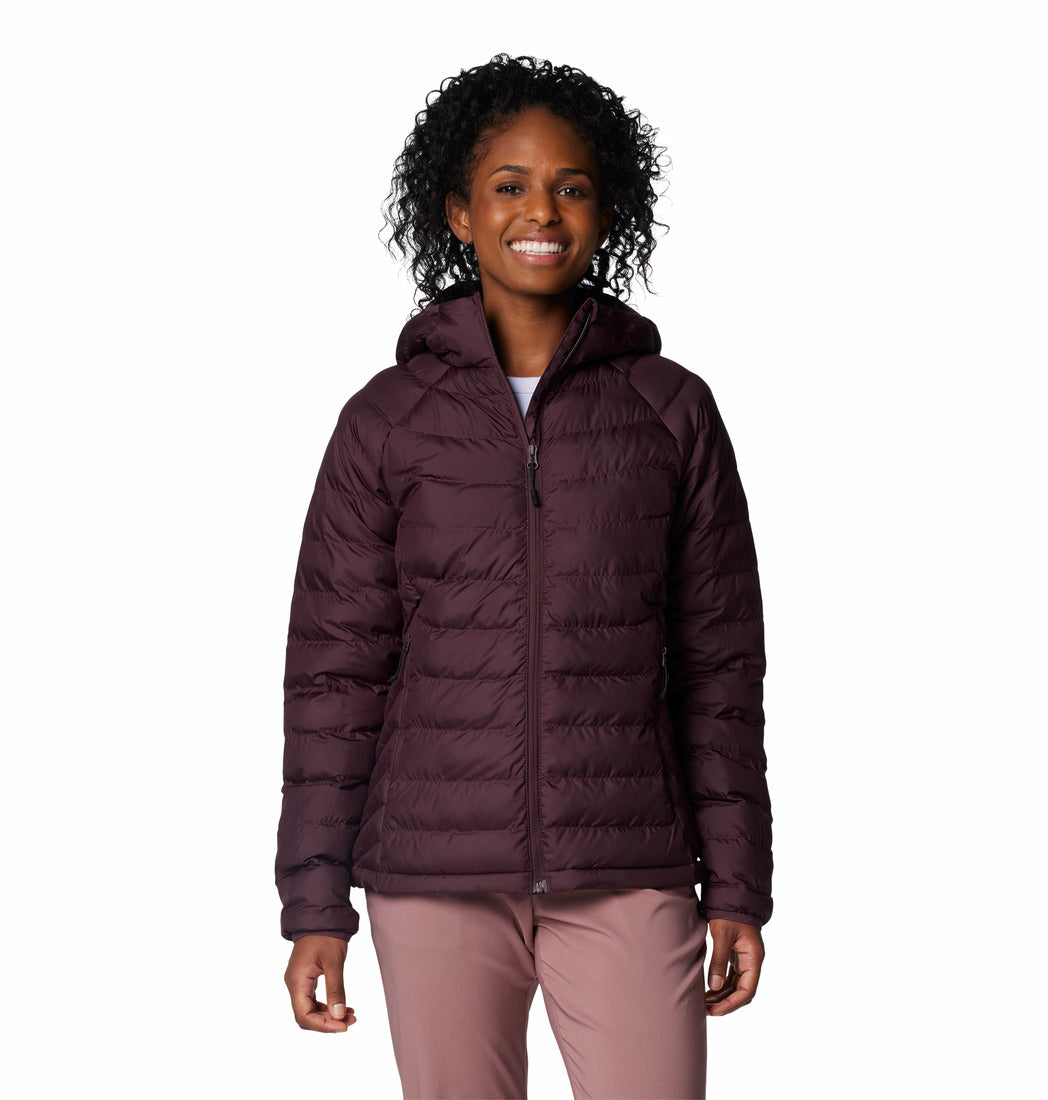 Woman wearing a purple puffer jacket on a white background