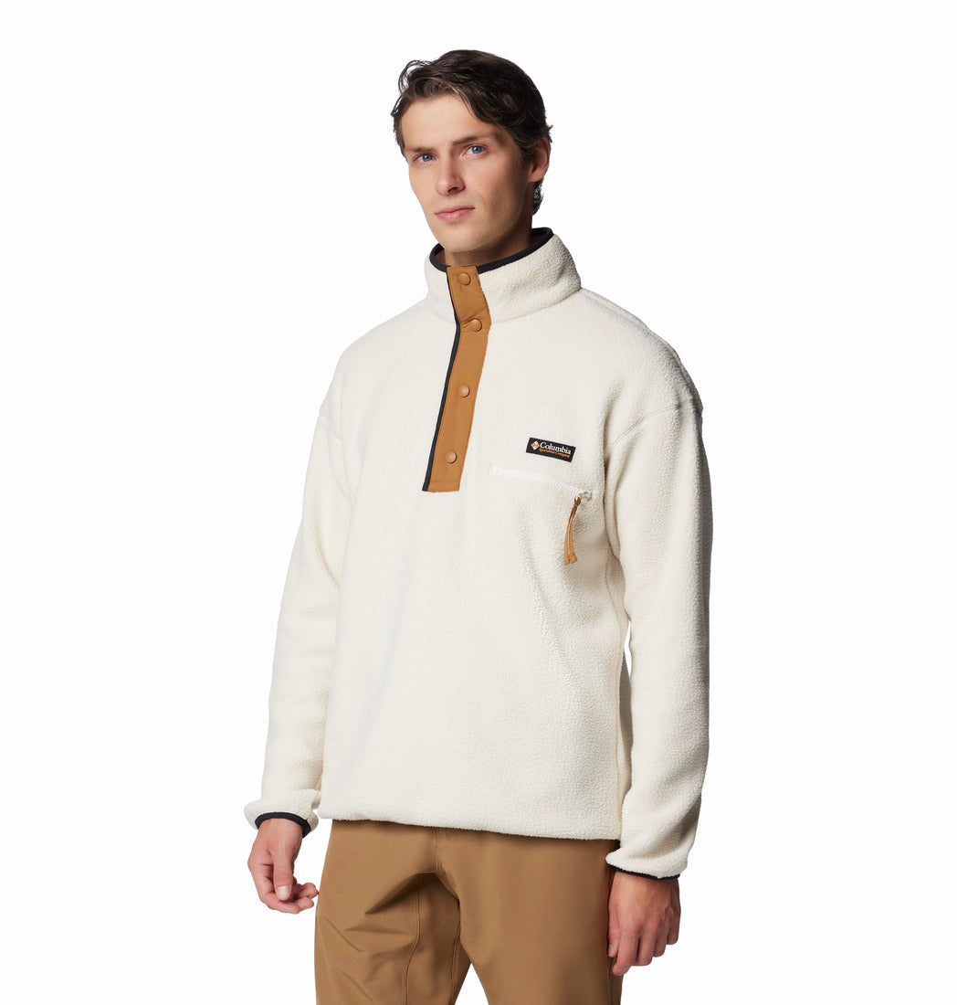 Man wearing a white fleece pullover with a brand logo on a white background