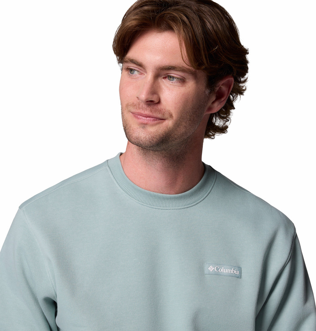 Man wearing a light blue Columbia sweatshirt on a white background