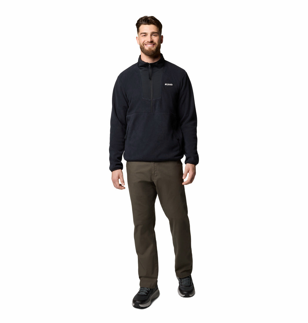 Man wearing a black pullover and green pants on a white background