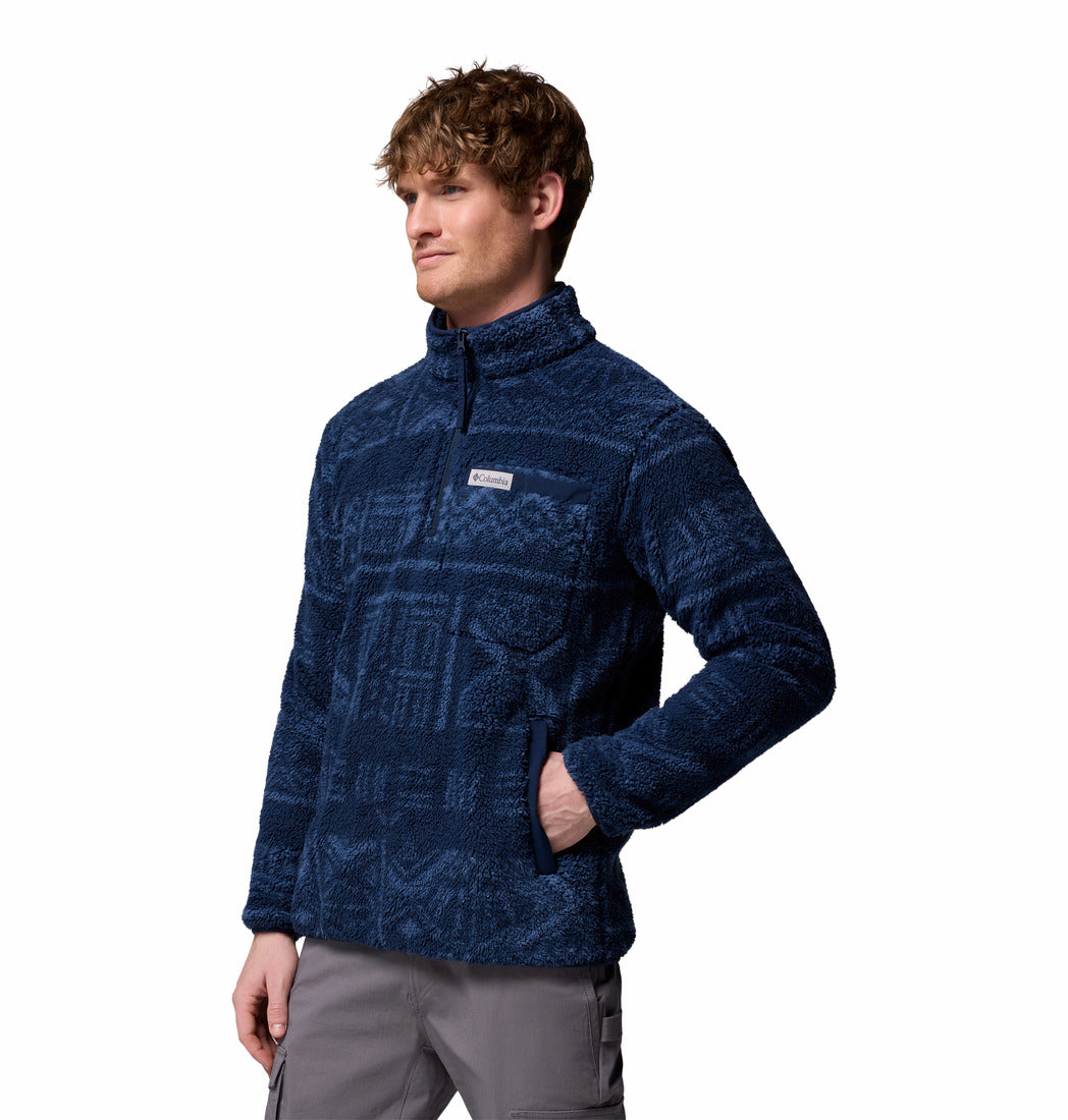 Man wearing a blue patterned pullover fleece on a white background