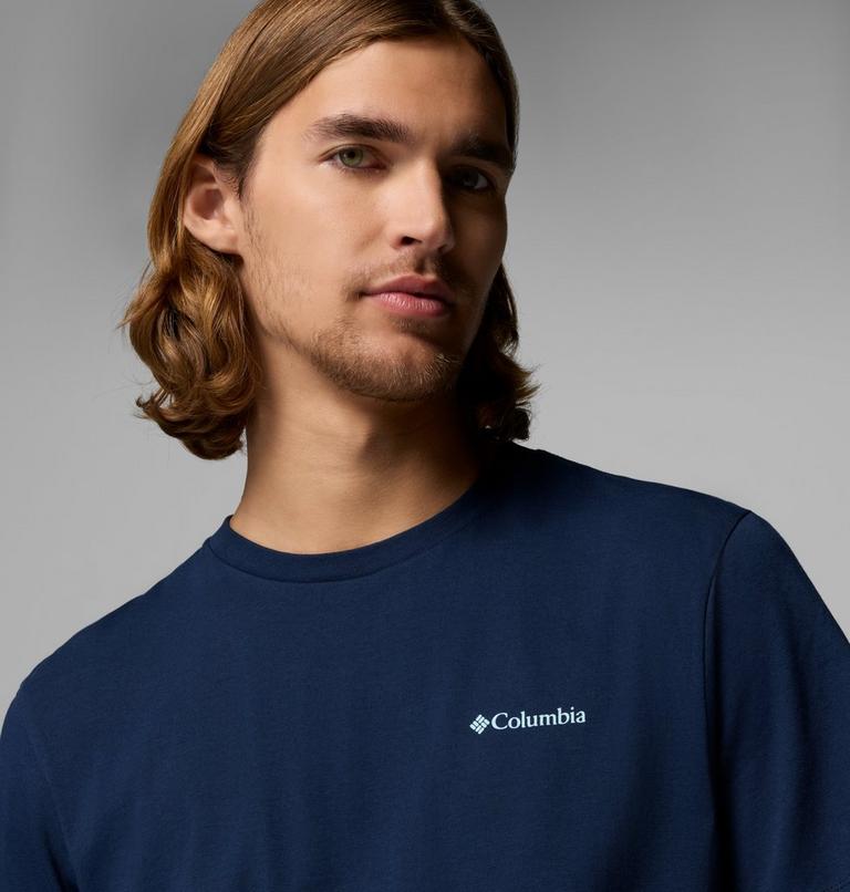 Man wearing a navy blue Columbia t-shirt against a gray background