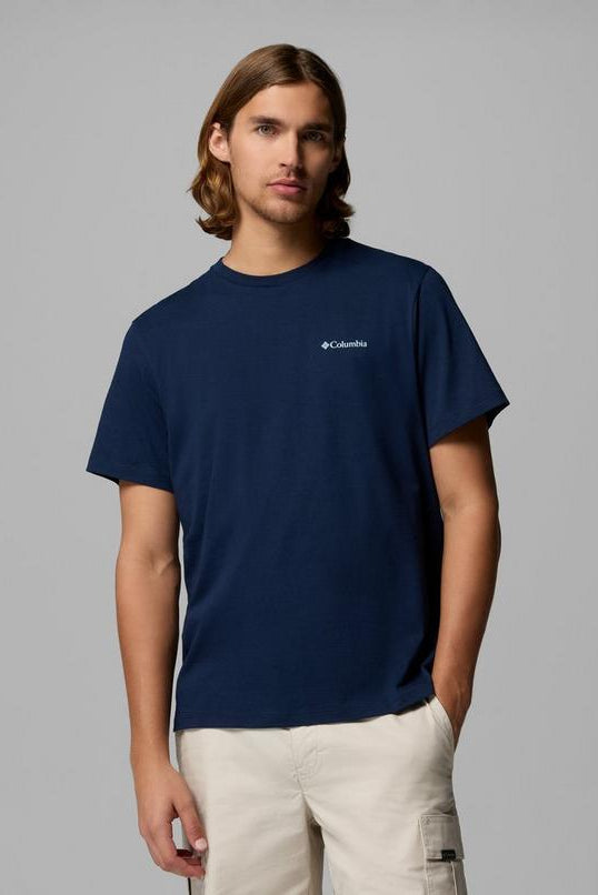 Person wearing a navy Columbia t-shirt against a gray background