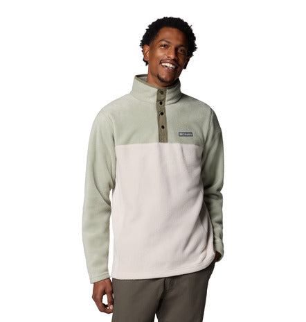 Man wearing a two-tone fleece pullover with a visible brand logo on a white background
