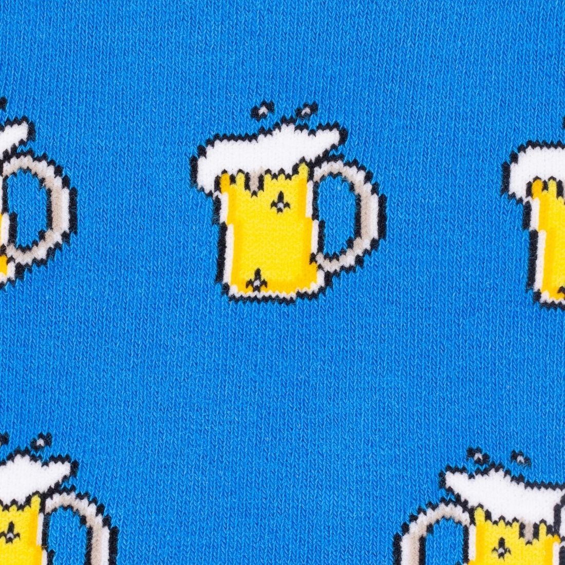 A close-up of a blue knit fabric featuring a repeating pattern of pixel-art beer mugs filled with yellow beer and white foam.