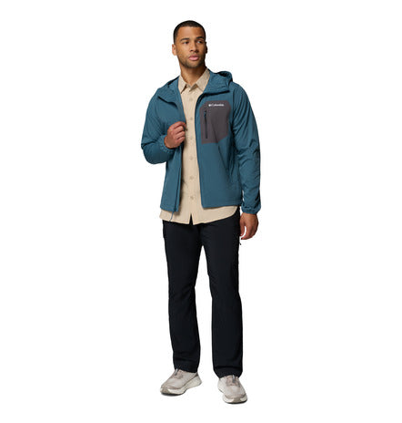Man wearing a blue jacket with a hood on a white background
