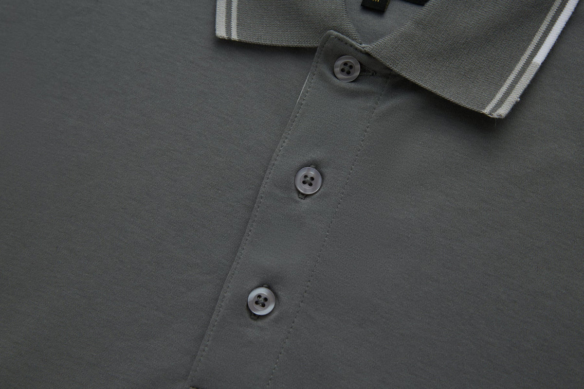 Close-up of the 6th Sense Astound December Polo in December, showing the placket with three buttons and the ribbed collar with white striped tipping.