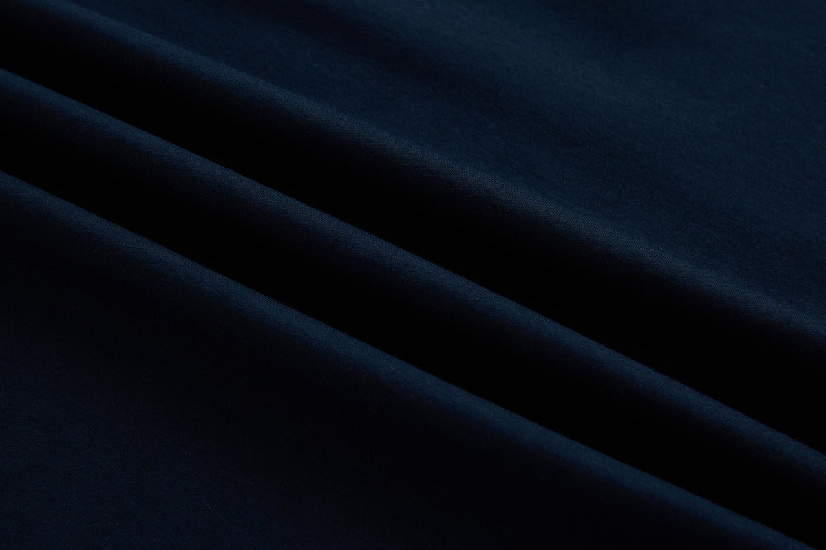 Close-up fabric detail of the 6th Sense Astound Eclipse Polo in Eclipse, showing diagonal folds and a smooth knit texture.