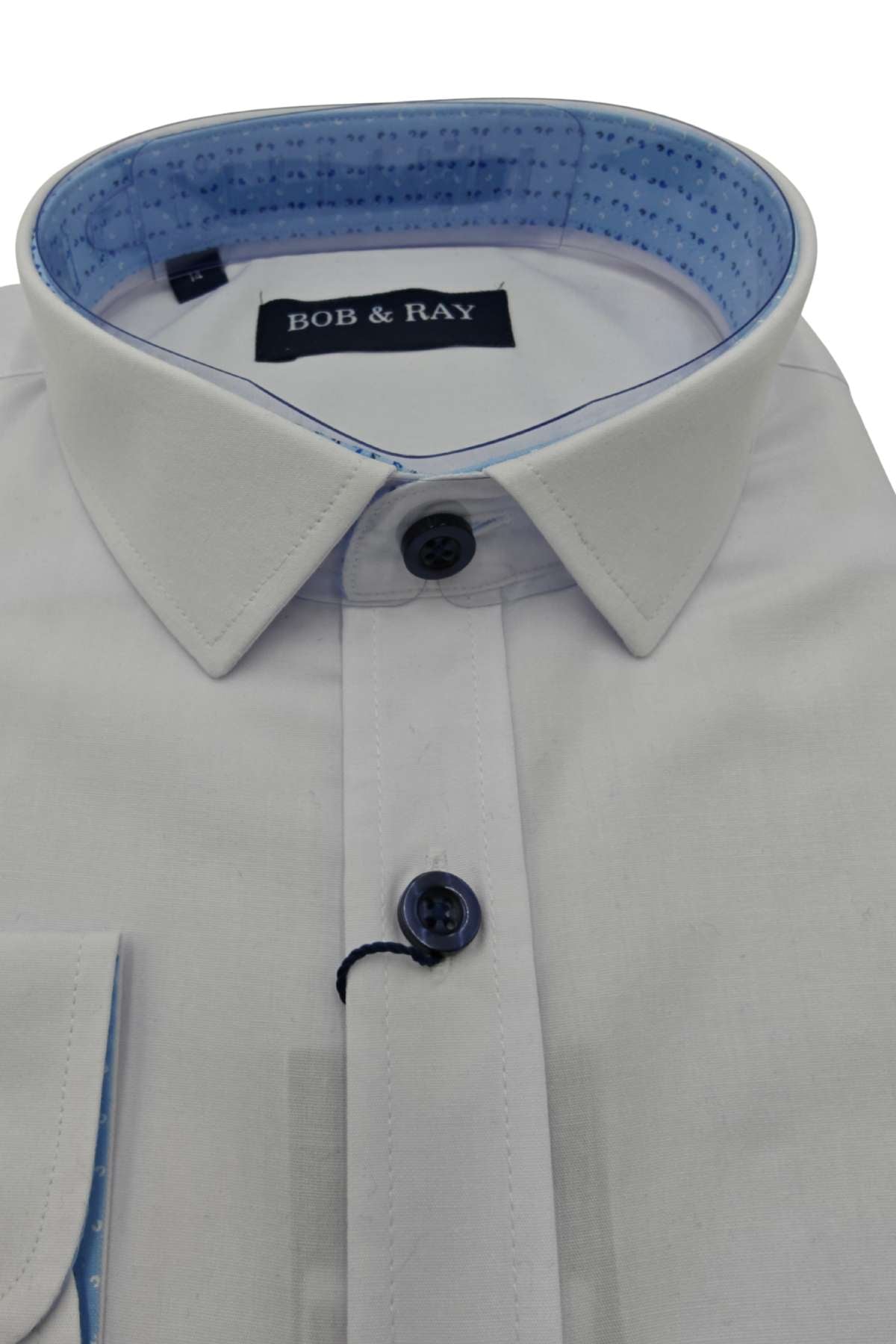 Folded boys white formal shirt with navy detail