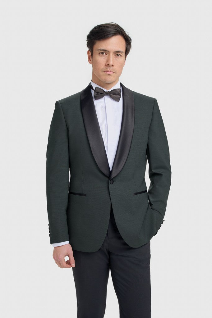 Man wearing a olive tuxedo with a bow tie on a white background