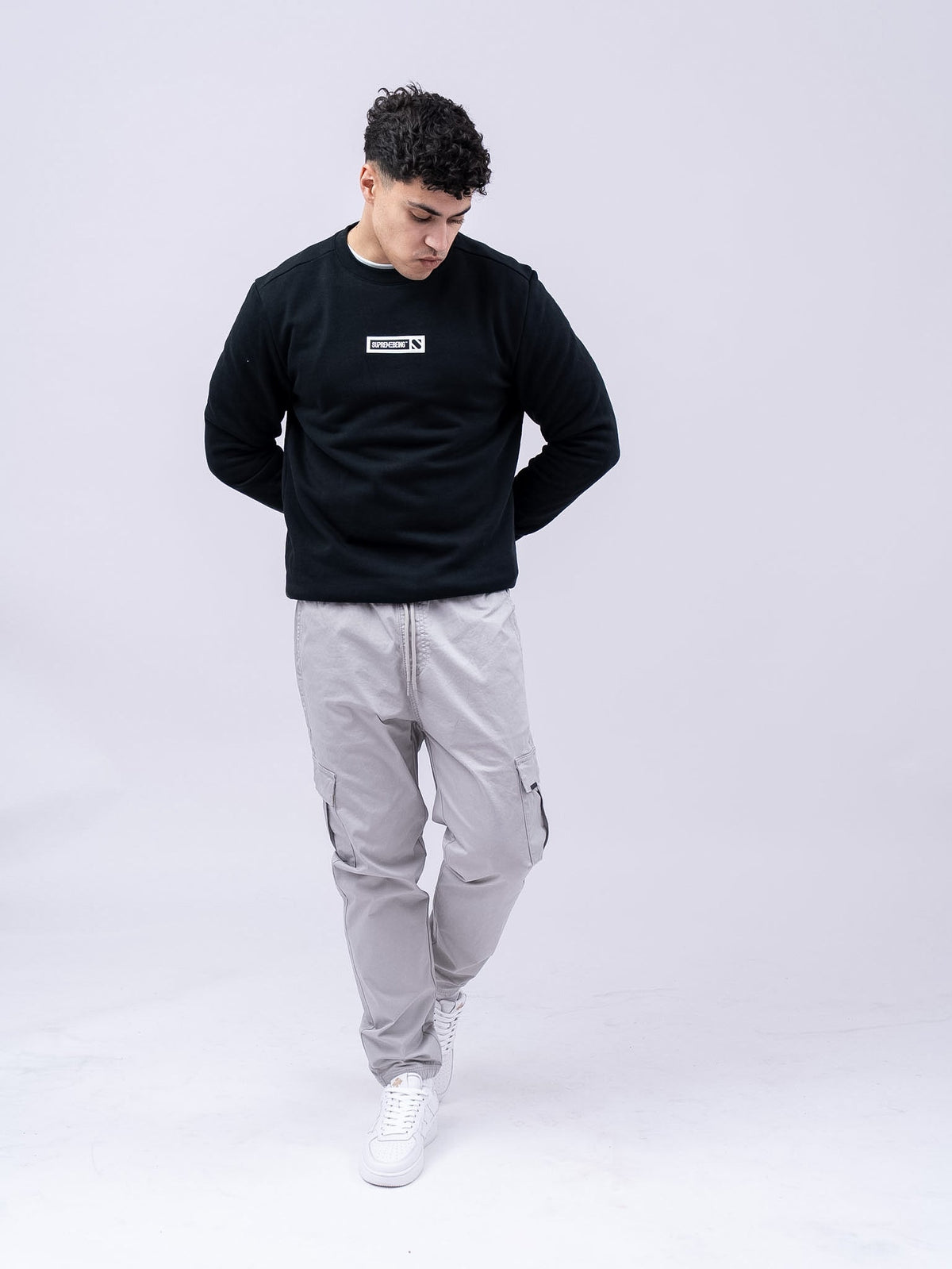 Supreme Being Element black crew-neck sweatshirt worn by model, front view