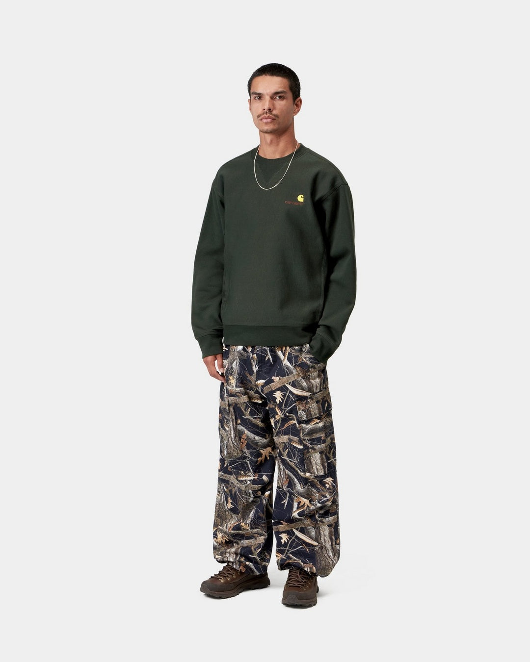 Carhartt WIP American Script Sweatshirt in Raven, shown worn on a model with small chest logo embroidery.