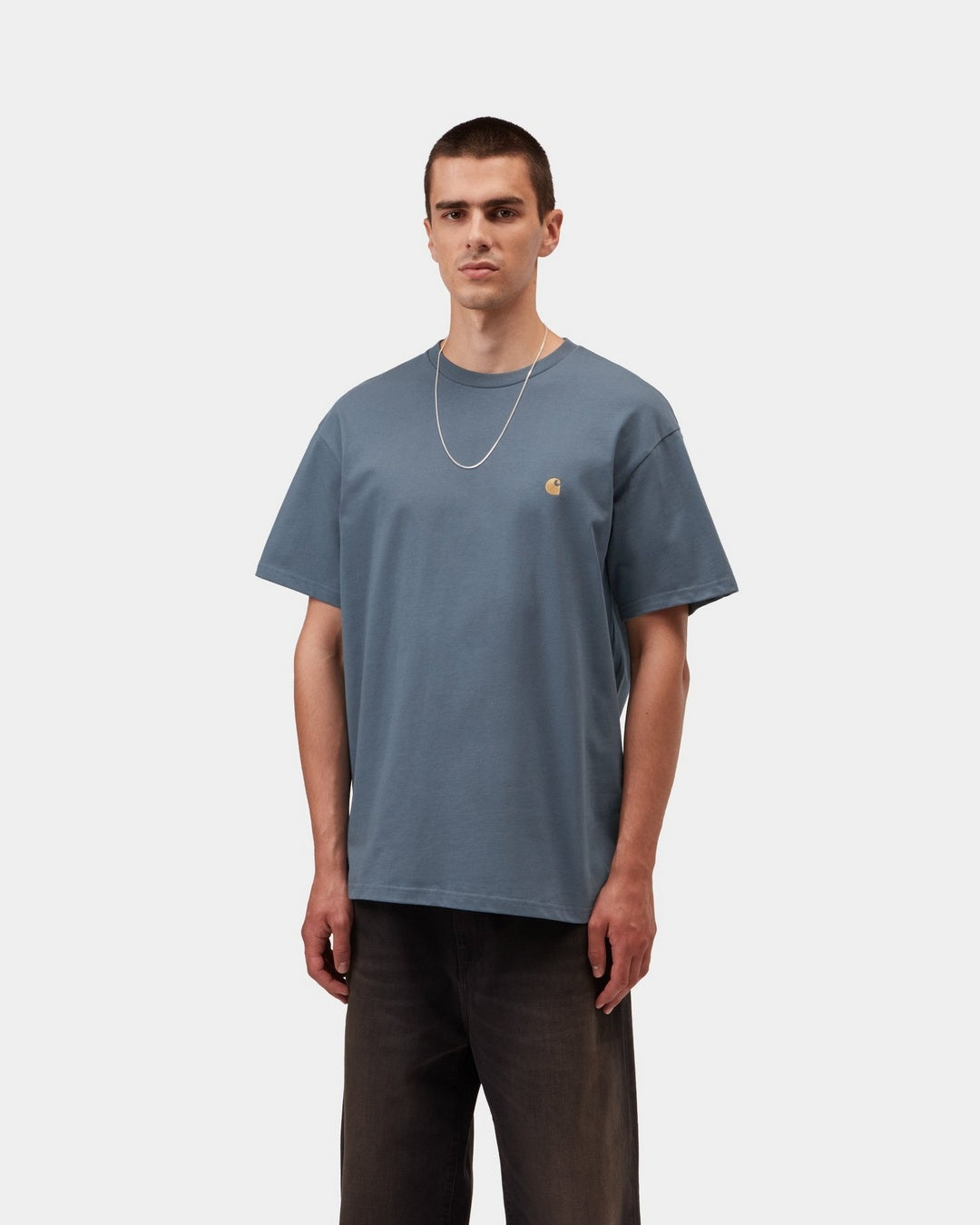 Carhartt WIP S/S Chase T-Shirt in Icesheet / Gold, front view, with gold embroidered chest logo, shown on model.