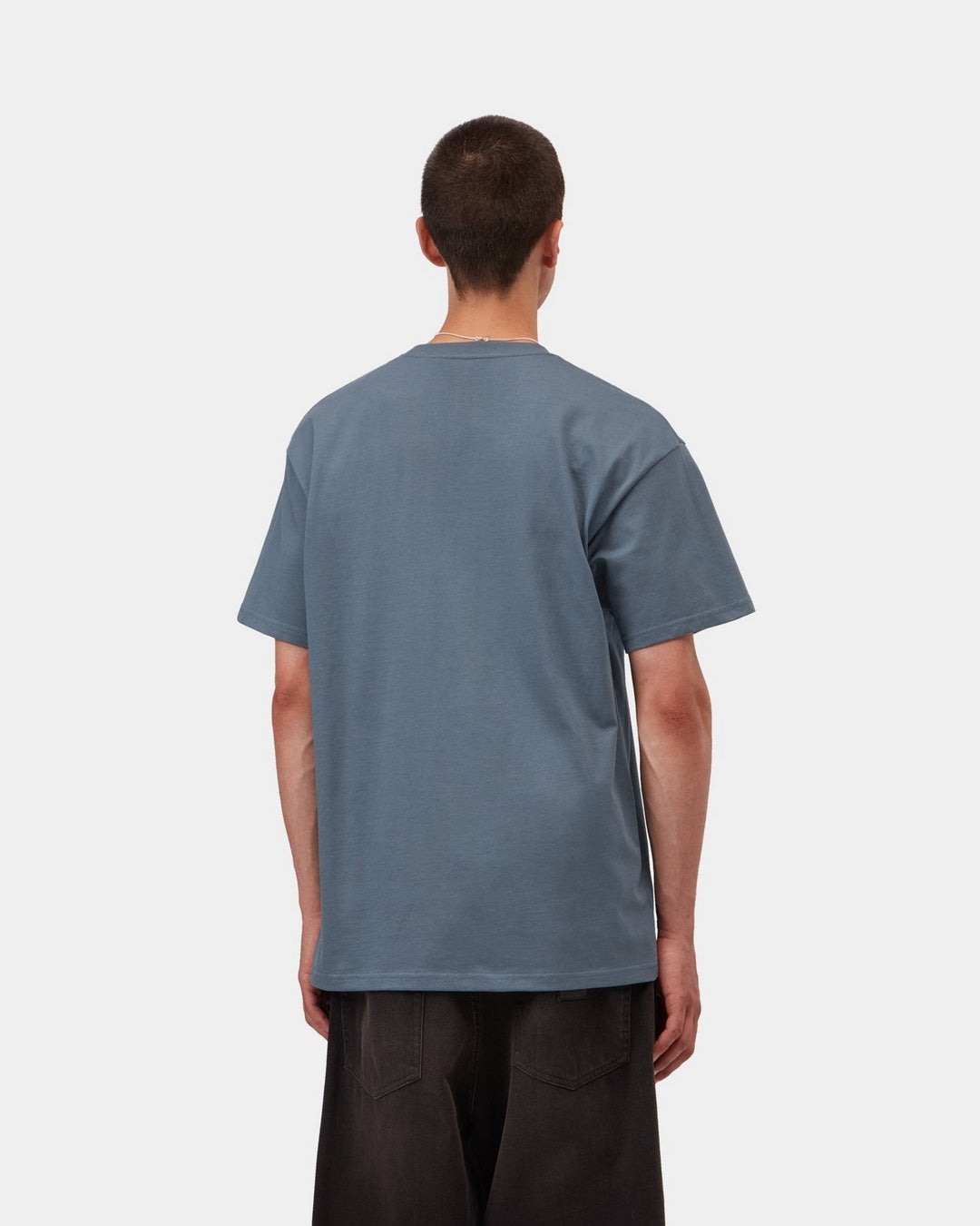 Back view of a Carhartt WIP S/S Chase T-Shirt in Icesheet / Gold, shown on a model with a loose fit.
