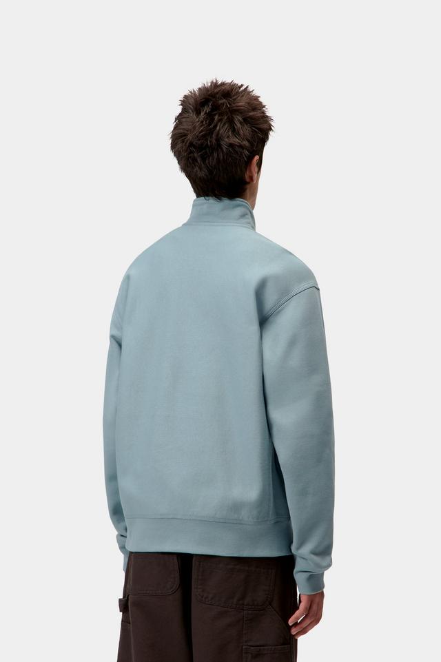 Person wearing a light blue sweatshirt on a white background
