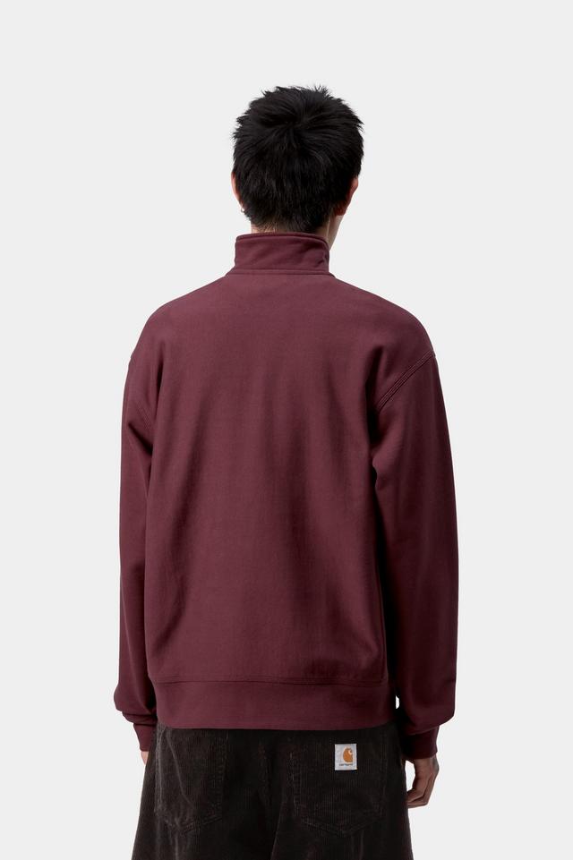 Person wearing a maroon half-zip sweatshirt on a white background