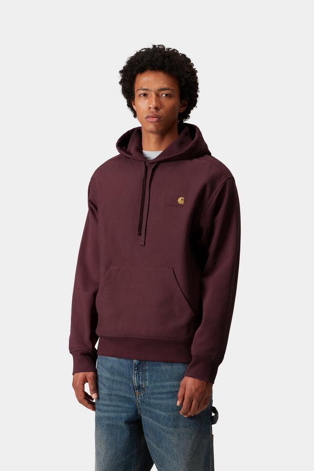 Man wearing a maroon hoodie with a brand logo on a white background