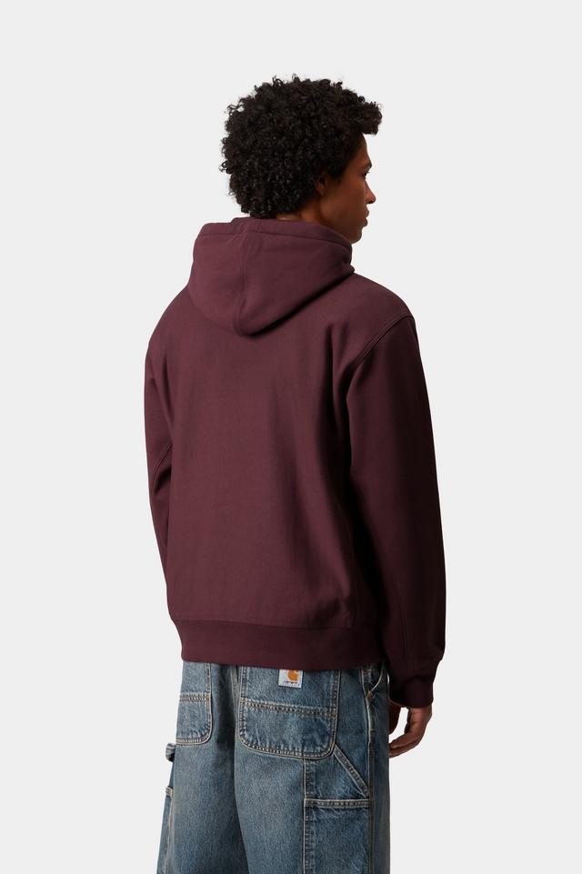 Person wearing a maroon hoodie and blue jeans on a white background